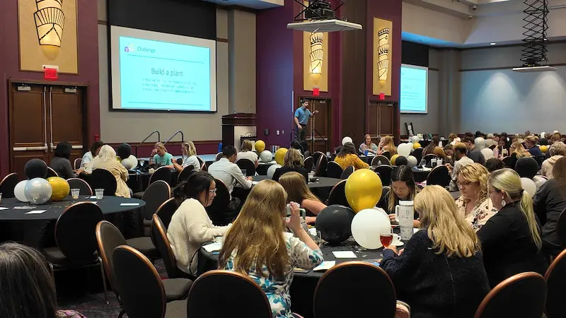 wide-crowd-2-regular Andrew speaking at the front of a large conference audience
