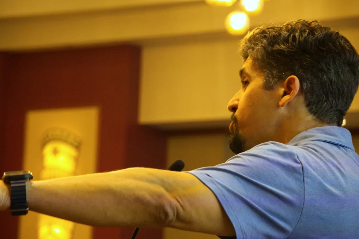 andrew-berrigan-action-close-up Andrew Berrigan speaking with his arm outstretched during a conference session