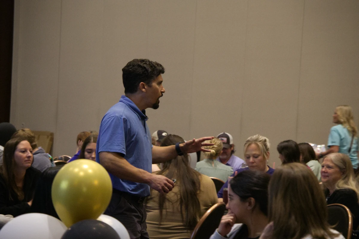 andrew-berrigan-walking-through-audience Andrew Berrigan speaking while walking among seated conference participants