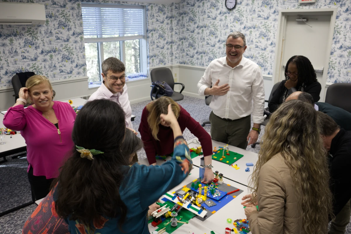 workshop-audience-laughter Workshop participants laughing together as they build colorful LEGO models